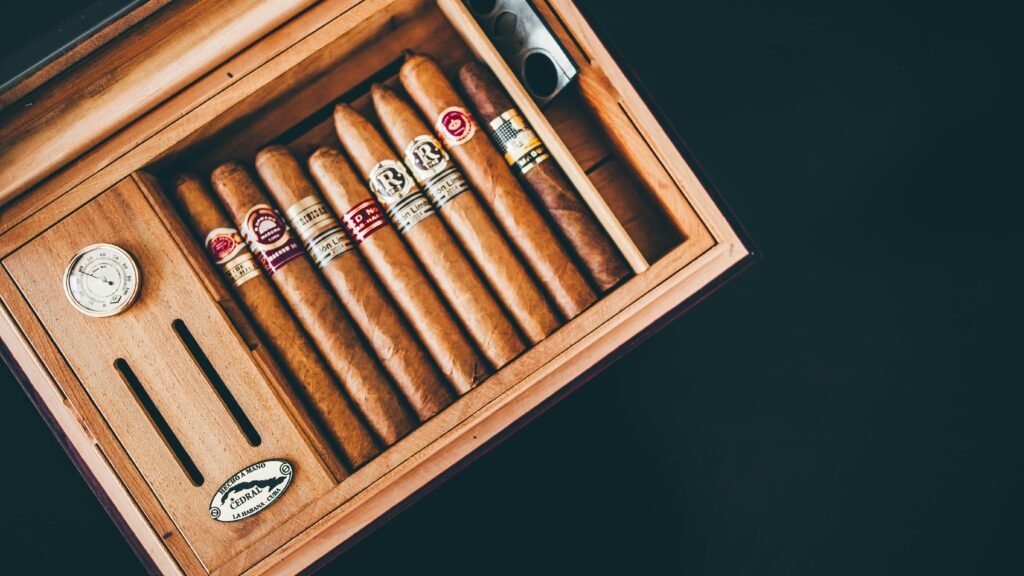 Close-up of premium Cuban cigars in a wooden humidor box, showcasing luxury and craftsmanship.