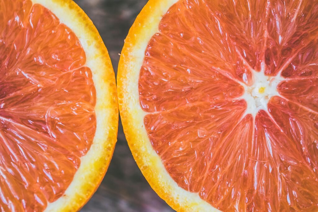 Detailed close-up of fresh grapefruit slices showcasing vibrant colors and textures.