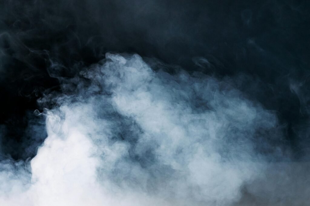Captivating image of ethereal smoke on a dark backdrop, ideal for creative projects.