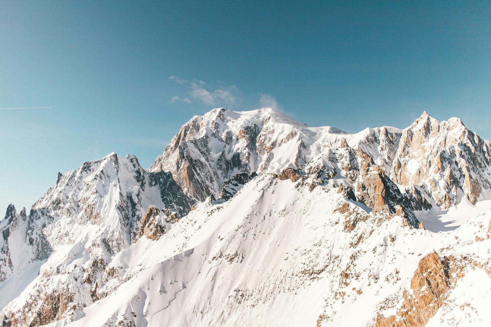 Majestic snowcapped mountains of Montblanc captured under a clear blue sky.